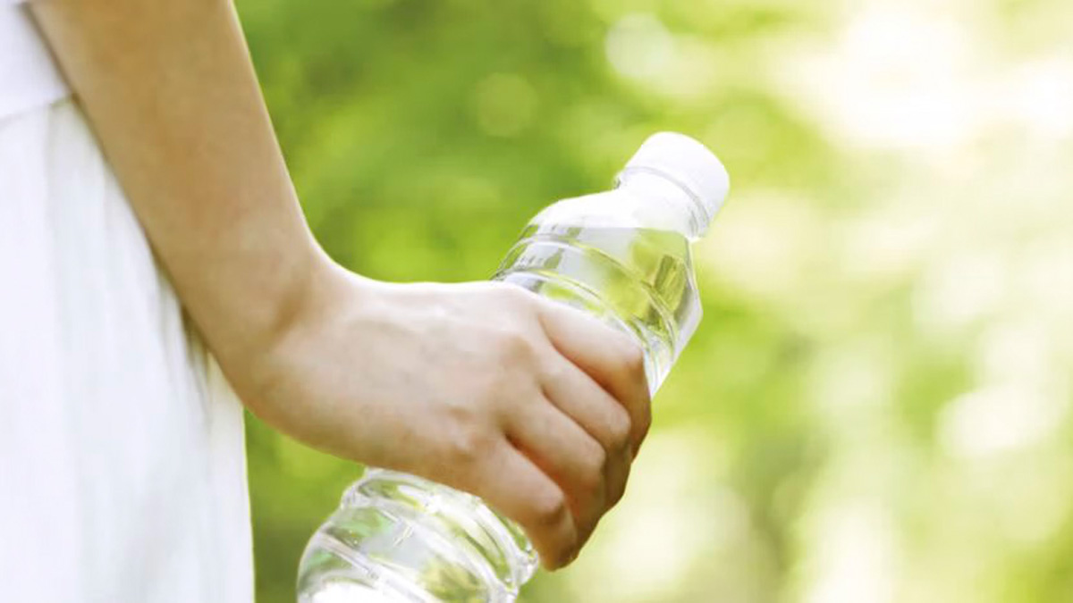 Bottle in hand, greens
