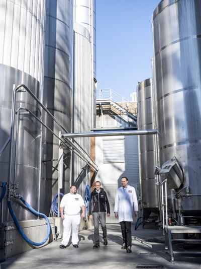 Kommen mit der kleinen Water Saving Unit beim Wassersparen hoch hinaus: Geschäftsführer Andreas Naarmann (rechts), Sven Irrgang von GEA und Projektleiter Michael Frenking (links). Die Molkerei Naarmann spart pro Betriebsstunde des Separators 300 Liter Wasser ein. (Bild: GEA)