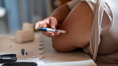 Taking an insulin syringe at home
