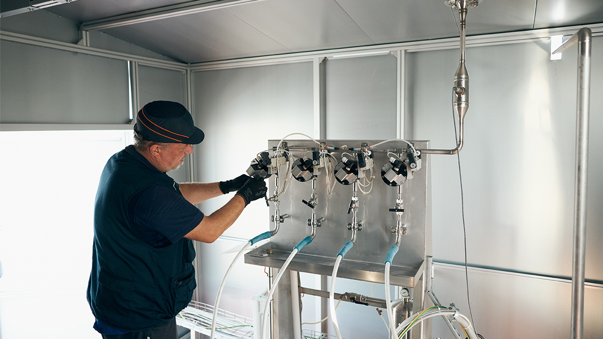 A technician operates a specialized valve arrangement for the GEA spray dryer system