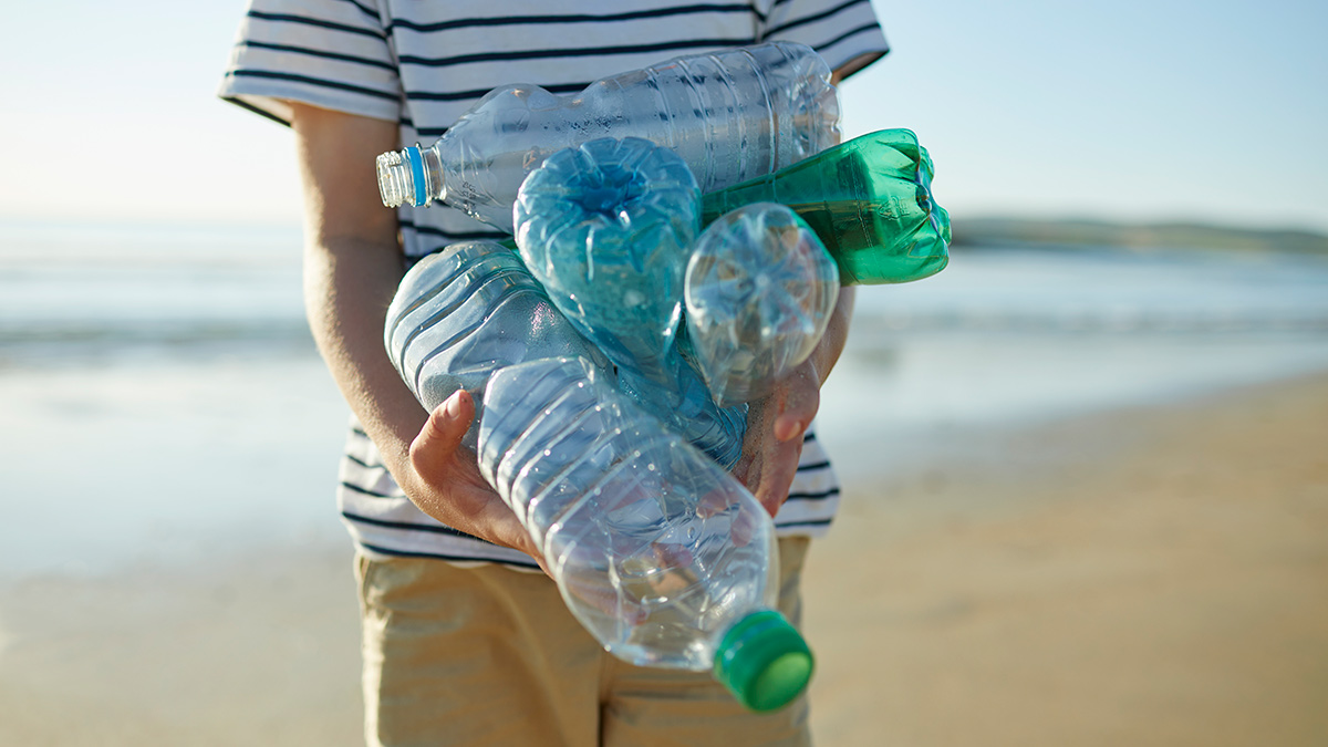 child collecting PET bottles