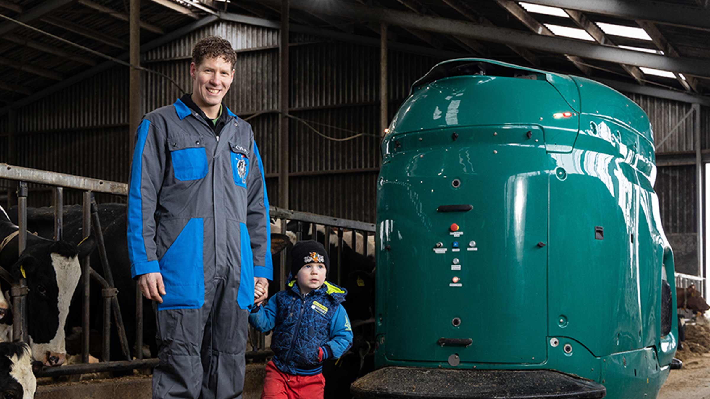 Theo van der Zwaag from the Netherlands stands in front of a GEA automated feeding robot.